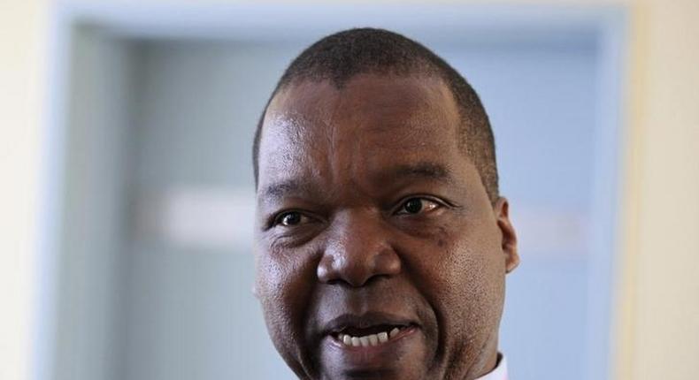 Zimbabwe's Reserve Bank Governor John Mangudya gestures while responding to questions in the country's parliament in Harare June 30, 2014. REUTERS/Philimon Bulawayo