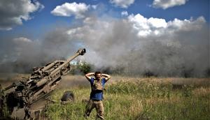 A soldier covers his ears as an M777 howitzer is fired on the frontline in Zaporizhzhya.Gian Marco Benedetto/Anadolu Agency via Getty Images