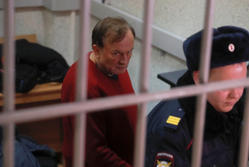 Russian historian Sokolov is escorted inside a court building in Saint Petersburg