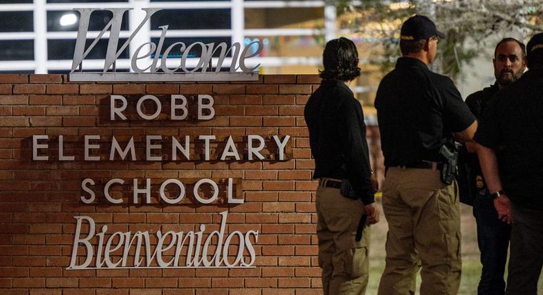 Law enforcement officers speak together outside of Robb Elementary School following the mass shooting at Robb Elementary School on May 24, 2022 in Uvalde, Texas. According to reports, 19 students and 2 adults were killed, with the gunman fatally shot by law enforcement.