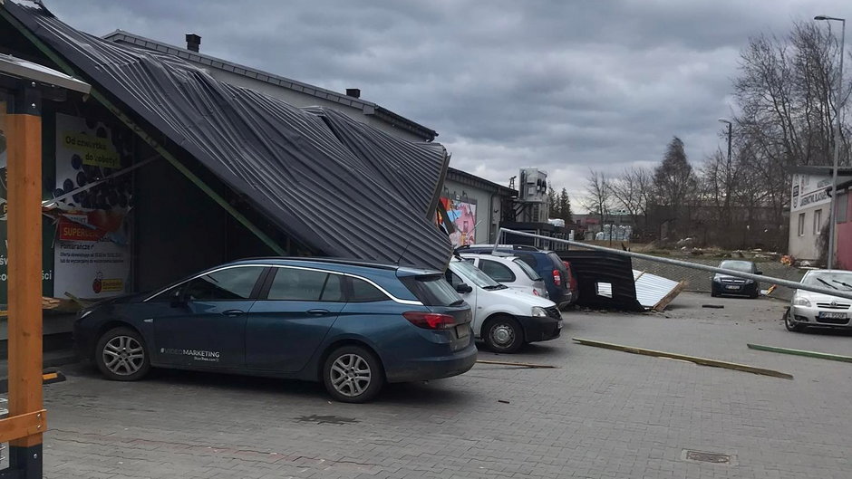 Zerwany dach warsztatu samochodowego spadł na market przy ul. Dworcowej 