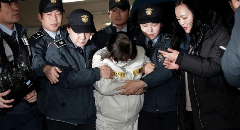 Choi Soon-sil (C), the jailed confidante of South Korean President Park Geun-hye, arrives for questioning into her suspected role in a political scandal at the office of the independent counsel in Seoul on December 24, 2016