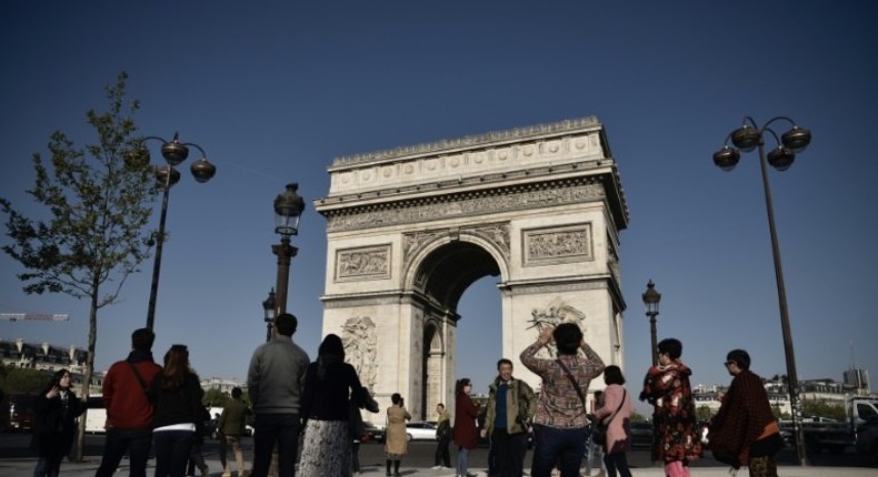 Tourists returned to the Champs Elysees on Friday, with many vowing that the killing of a policeman on the world-famous avenue would not stop them from coming