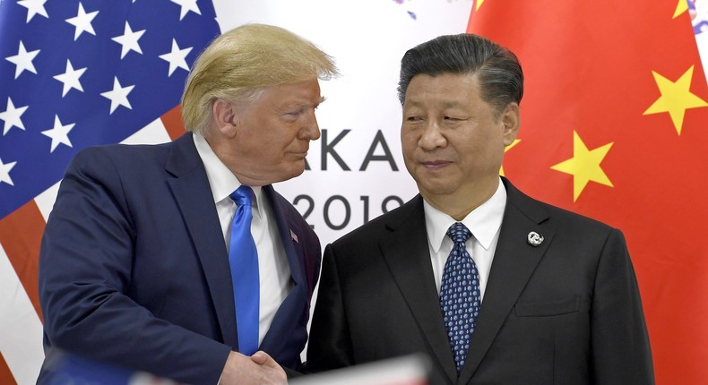 In this June 29, 2019, file photo, U.S. President Donald Trump, left, shakes hands with Chinese President Xi Jinping during a meeting of the G-20 summit in Osaka, western Japan.