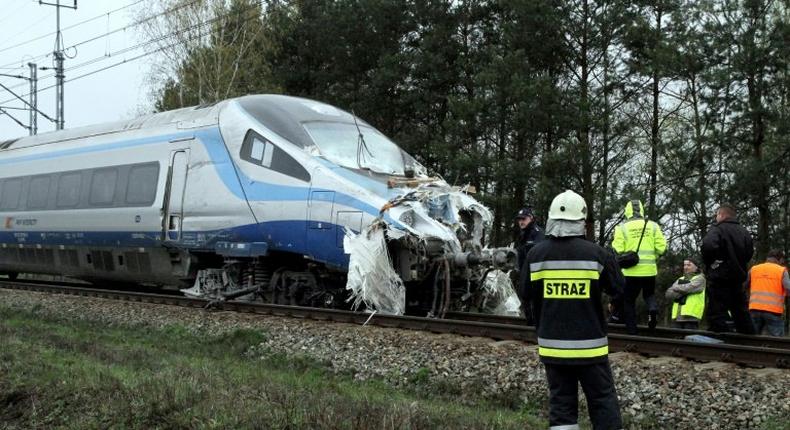 Emergency services work at the scene of a collision between a train and a truck in Schodnia, south Poland, on April 7, 2017