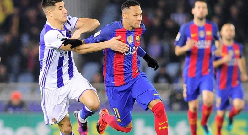 Real Sociedad's defender Yuri Berchiche (L) vies with Barcelona's Brazilian forward Neymar da Silva Santos Junior during the Spanish league football match Real Sociedad vs FC Barcelona at the Anoeta stadium in San Sebastian, on November 27, 2016