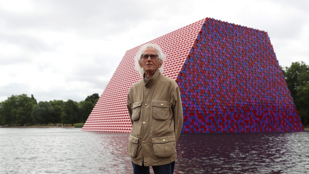 Artist Christo stands in front of his work The London Mastaba, on the Serpentine in Hyde Park, Londo