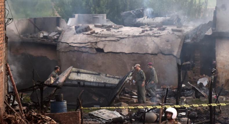 Pakistani soldiers cordon off the site where an aircraft crashed in Rawalpindi