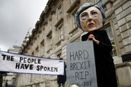 Protestor wearing a Theresa May mask is seen the day after Britain's election in London