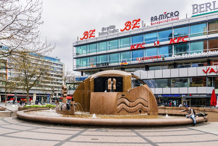 <strong>Ku'damm</strong>
<br></br>
Główna ulica zachodniej części Berlina, położona w okręgu Charlottenburg-Wilmersdorf. Ku’damm to potoczny i powszechnie używany przez Berlińczyków skrót od słowa Kurfürstendamm  (dosł. Grobla Elektorska). Ulica łączy Breischeidplatz z Kościołem Pamięci w Charlottenburgu oraz Rathenauplatz w Wilmersdorfie. Nazwa ulicy wywodzi się od słowa Kurfürst, oznaczającego księcia elektora Świętego Cesarstwa Rzymskiego.
<br></br>
Ulica powstała niemal 500 lat temu jako poprowadzona groblą droga konna z zamku w Berlinie do zamku Grunewald. Droga została rozbudowana do miejskiego bulwaru z inicjatywy kanclerza Ottona von Bismarcka. 
<br></br>