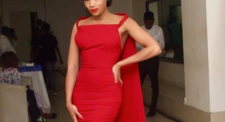 Bonang Matheba in a red embellised Weizdhurm Franklyn frock with stunning cape details