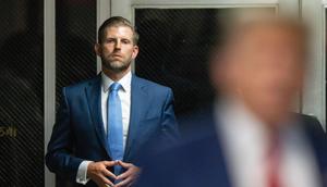 Eric Trump listens as his father, Donald Trump, speaks to the media in the courtroom hallway during the former president's criminal hush-money trial.Justin Lane-Pool/Getty Images