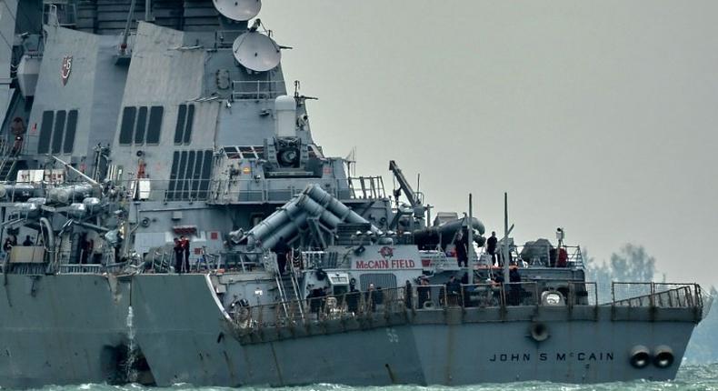 The guided-missile destroyer USS John S. McCain, with a hole on its portside after a collision with an oil tanker, makes its way to Changi naval base in Singapore