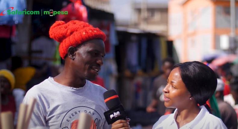 Pulse Kenya presenter Muthoni Irungu speaks with a business person in Nairobi's Kawangware area
