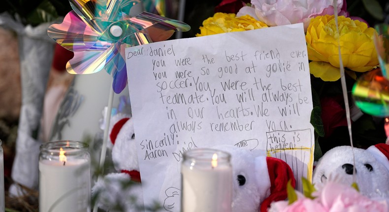 A letter sits among items left by neighbors during a vigil, Monday, May 1, 2023, outside the home where a mass shooting occurred Friday, in Cleveland, Texas.David J. Phillip/AP News