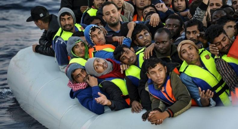 Migrants and refugees wait to be rescued off the Libyan coast on November 5, 2016