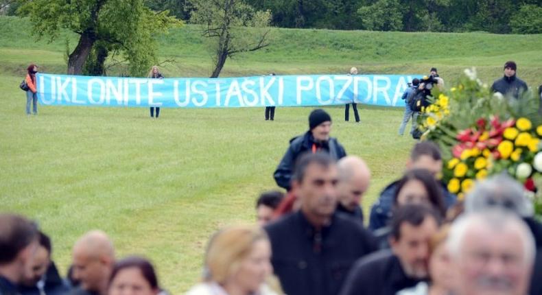 Activists hold an anti-fascist banner at a ceremony for the death camp victims of Croatia's former Nazi-allied regime