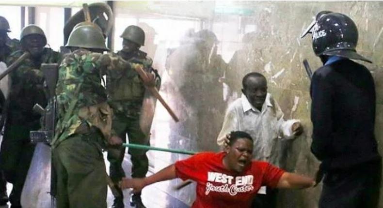 Police whipping Kenyans who were caught up in the night of terror