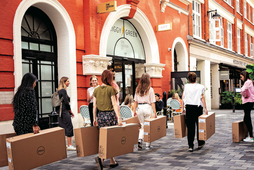 Company employees struggle to carry heavy boxes that contain Dell computing items through West End Streets, on 23rd August 2022, in London, England