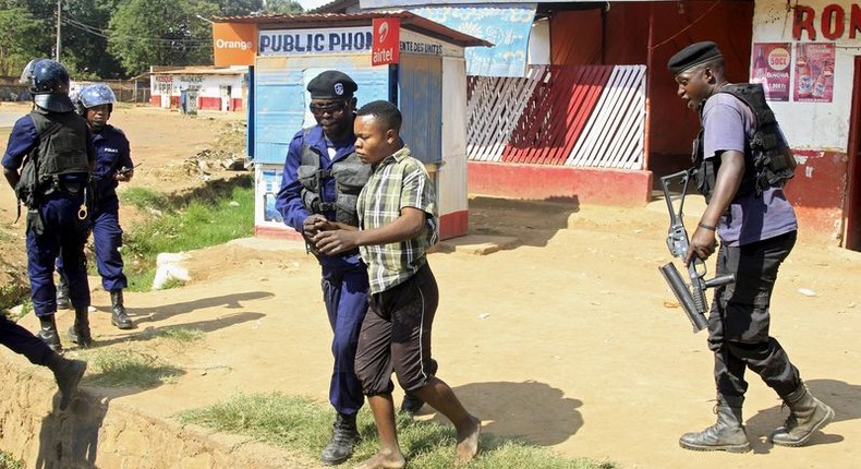 Policemen detain a protester during clashes in Lubumbashi, Democratic Republic of Congo November 10, 2015. REUTERS/Kenny Katombe