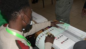 An IEBC clerk issues ballot papers to a voter during the 2022 General Election on August 9, 2022