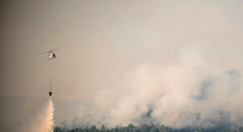 Over 200 firefighters were on the front line on Greece's second largest island, backed by 75 fire trucks, nine water-bombing helicopters and seven planes