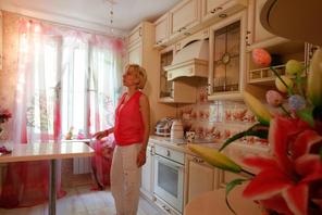 Anti-demolition activist Kari Guggenberger shows the kitchen of her apartment in a building to be de