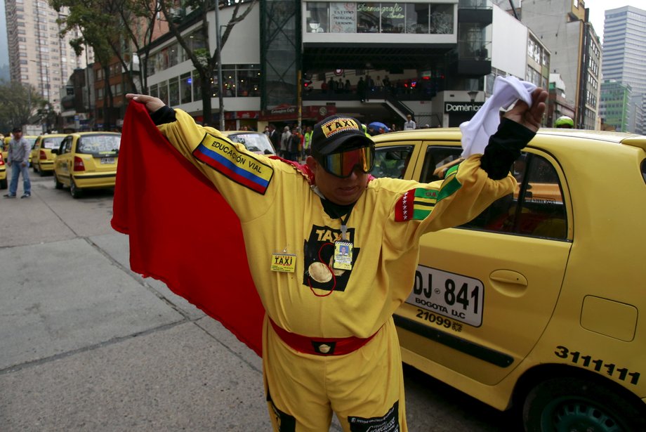 A cab driver dressed as a local character called "egg man" blocked an avenue to protest against Uber in Bogota on March 14.