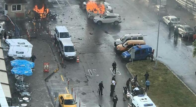 Cars burn in the street at the site of an explosion in front of the courthouse in Izmir, western Turkey on January 5, 2017