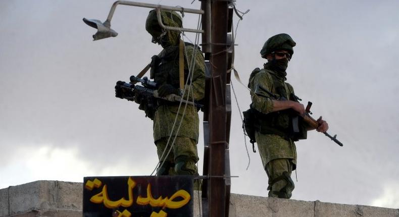 Russian soldiers patrol in a small Syrian village near the city of Hama on May 4, 2016