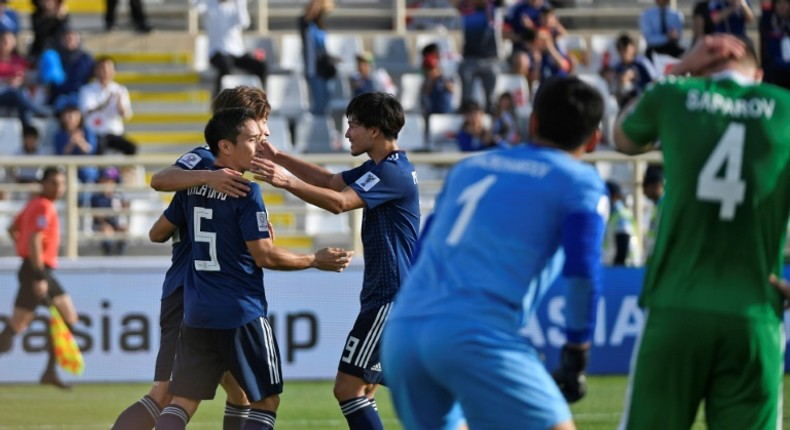 Yuya Osako is congratulated by Japanese teammates Yuto Nagatomo and Takumi Minamino after scoring in Wednesday's 3-2 win over Turkmenistan at the Asian Cup