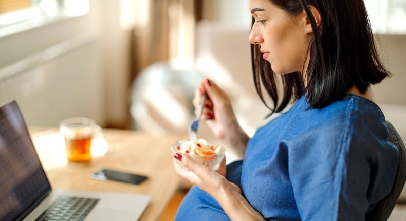 Plain yogurt with fresh fruit is a probiotic-packed snack great for people who are pregnant, or not.Damircudic / Getty Images