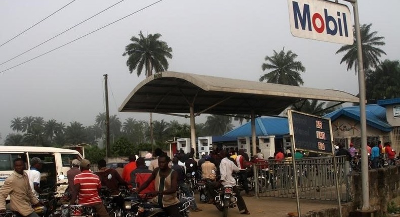 Motorists queue to buy petrol at a fuel station in Ahaoda in Nigeria's oil state in the Delta region, in a file photo. 