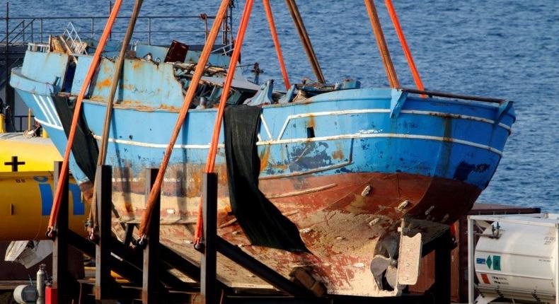 The wreck of a fishing boat that sank in April 2015, drowning hundreds of migrants packed on board, is seen after being raised in the Sicilian harbour of Augusta, Italy, July 1, 2016. 