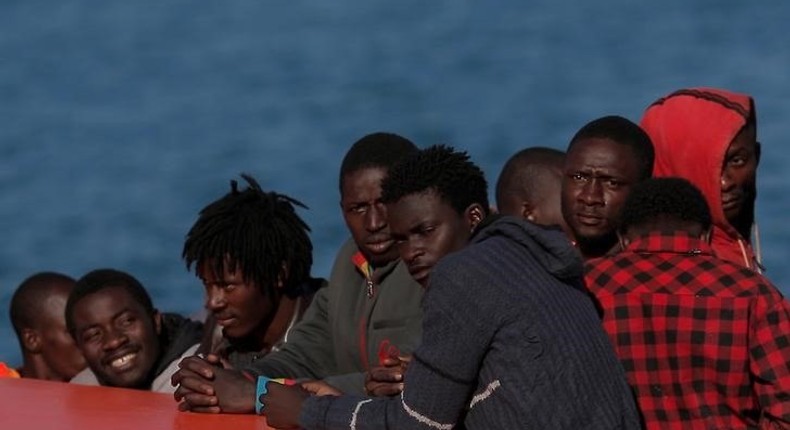 Migrants, who are part of a group intercepted aboard a makeshift boat off the coast in the Mediterranean sea, stand on a rescue boat upon arriving at a port in Malaga, southern Spain, May 19, 2016. 