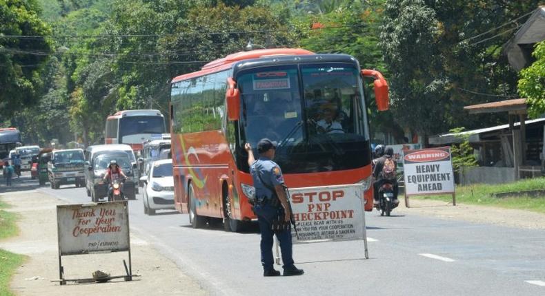 A Philippine policeman mans a checkpoint along a highway in Iligan City, in southern island of Mindanao on May 24, 2017