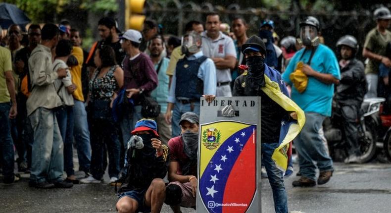 Opposition demonstrators block an avenue during an anti-government protest, in Caracas on June 29, 2017