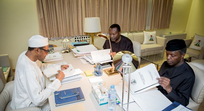 President Muhammadu Buhari, Vice President Yemi Osinbajo and Minister of Budget and National Planning Senator Udoma Udo Udoma read copies of the details of the submitted 2016 national budget by the National Assembly in Abuja, Nigeria April 10, 2016 