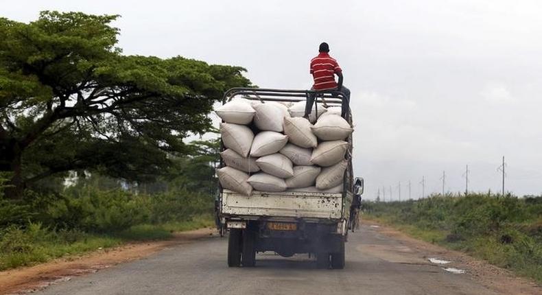 A man rides atop a truck ferrying bags of maize to a market along a road in the outskirts of Burundi's capital Bujumbura, April 30, 2015. REUTERS/Thomas Mukoya