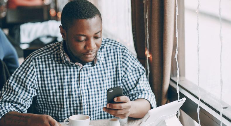 man texting working coffee shop