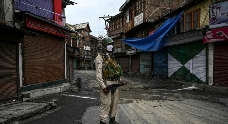 An Indian security force member stands guard in Srinagar, in Indian Kashmir, near the Jamia Masjid, the city's grand mosque