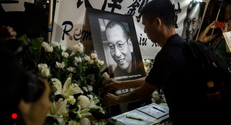 Democracy activists and members of the public gathered outside China's liaison office in Hong Kong Thursday night to mourn the death in custody of China's Nobel laureate Liu Xiaobo and vent their anger at Beijing.