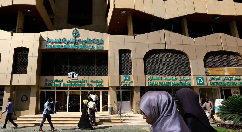 People walk past the Faisal Islamic Bank in Khartoum, Sudan January 12, 2016.