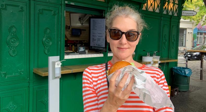 Author Jennifer Ceaser with a burger on a brioche bun from Burgermeister.Jennifer Ceaser
