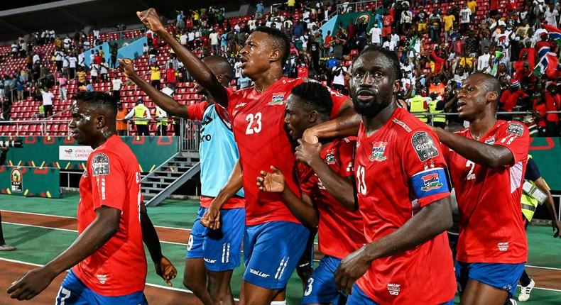 Gambia substitute Ablie Jallow (3R) celebrates with teammates after scoring the goal that beat Tunisia in an Africa Cup of Nations Group F match in Limbe on Thursday