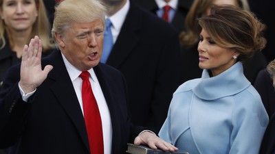 Donald Trump takes the oath of office as his wife Melania holds a bible during his inauguration as the 45th president of the United States on the West front of the U.S. Capitol in Washington