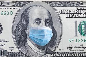 US quarantine, 100 dollar banknote with medical mask. The concept of epidemic and protection against coronavrius.