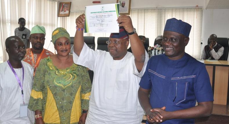 Otunba Ademola Adeleke raises his certificate of return above his head after it was presented to him by the Independent National Electoral Commission (INEC) on Tuesday, July 11, 2017