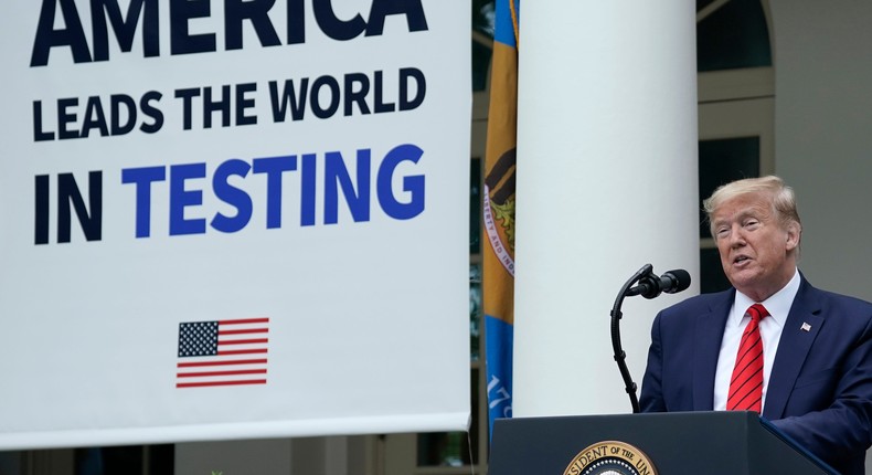 President Donald Trump, flanked by tables holding testing supplies and machines, speaks during a press briefing about coronavirus testing in the Rose Garden of the White House on May 11, 2020 in Washington, DC.