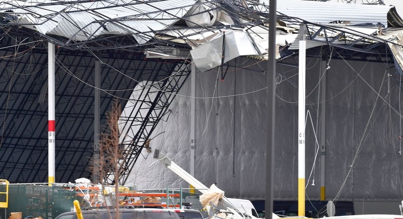 Workers remove debris from an Amazon Fulfillment Center in Edwardsville, Illinois, on December 11, 2021, after it was hit by a tornado.